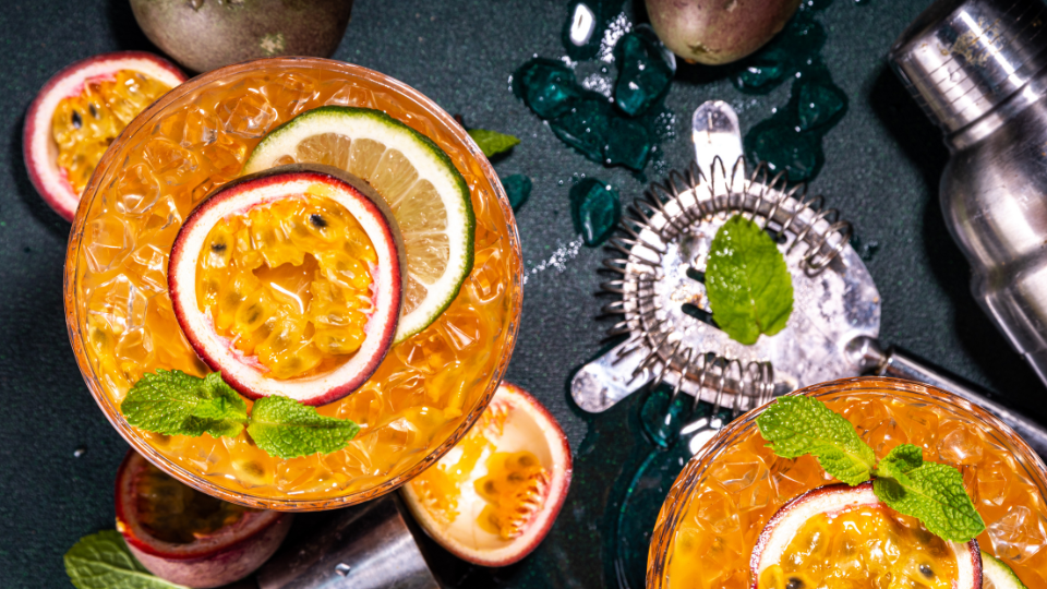 passionfruit drink on dark background with cocktail shaker