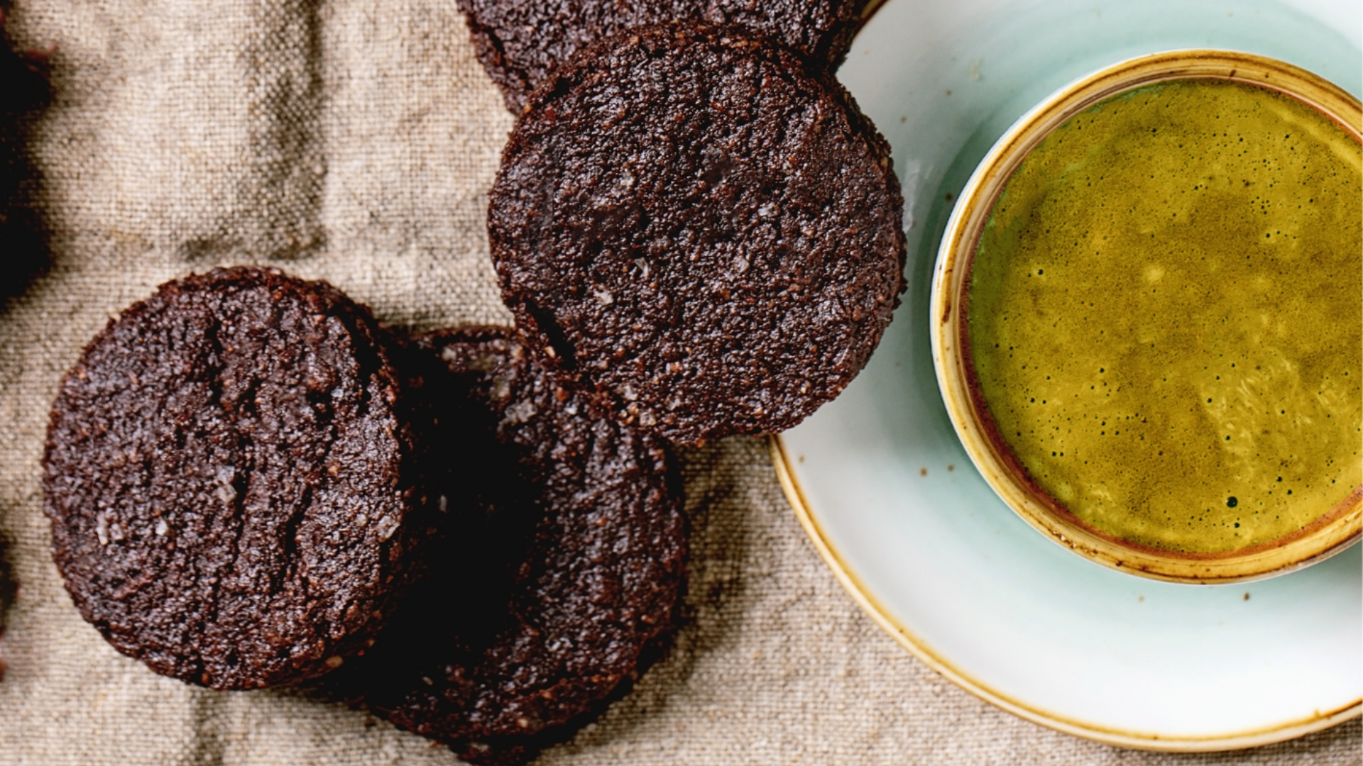 chocolate shortbread cookies next to a cup of matcha