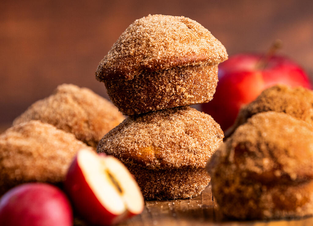 Golden milk apple cider donut muffins coated in cinnamon sugar, identical to our apple cider donut muffins on the outside